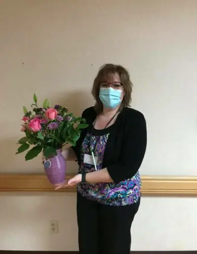employee holding roses