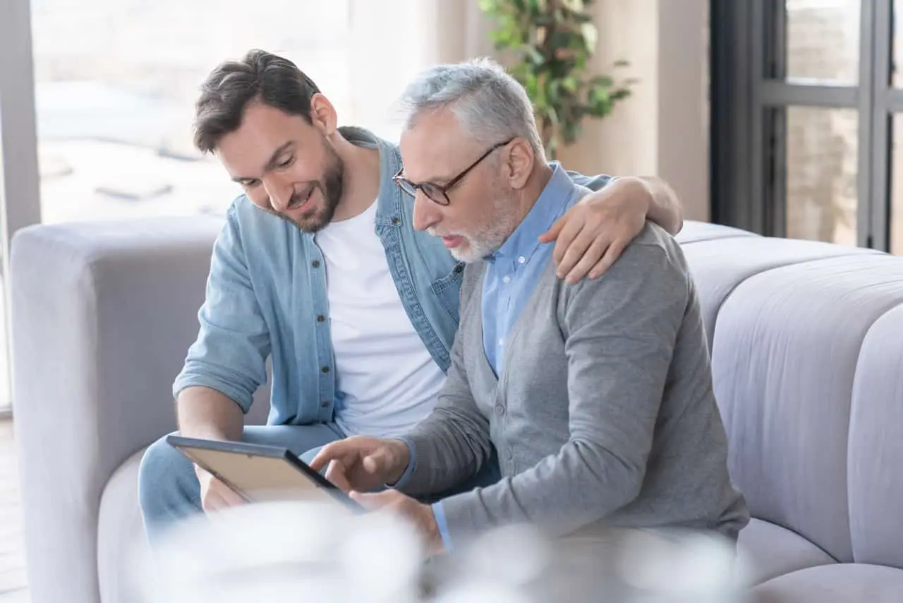 Adult son talking to elderly father about plans for the future