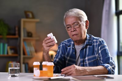 Confused Senior with Medication Bottles
