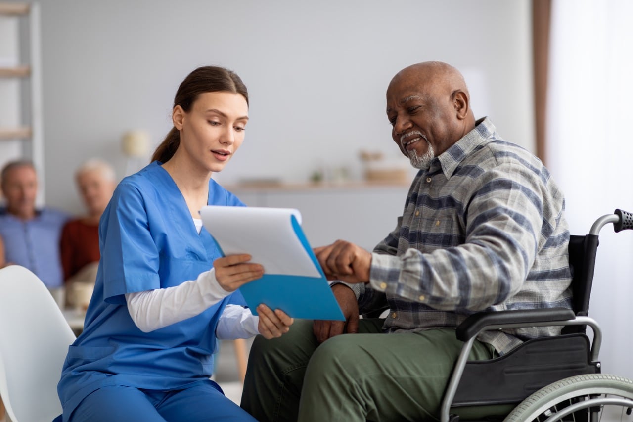 A nurse talking to an elderly patient about post acute care