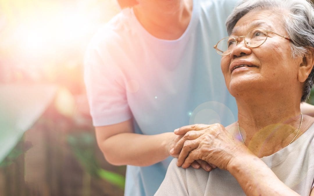 A senior being welcomed into an assisted living facility