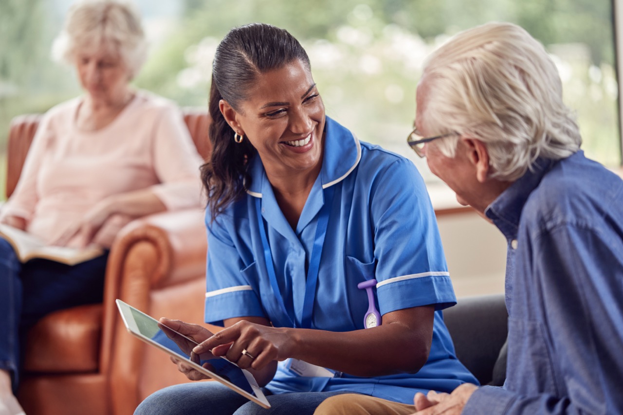 A senior being given support by a nurse