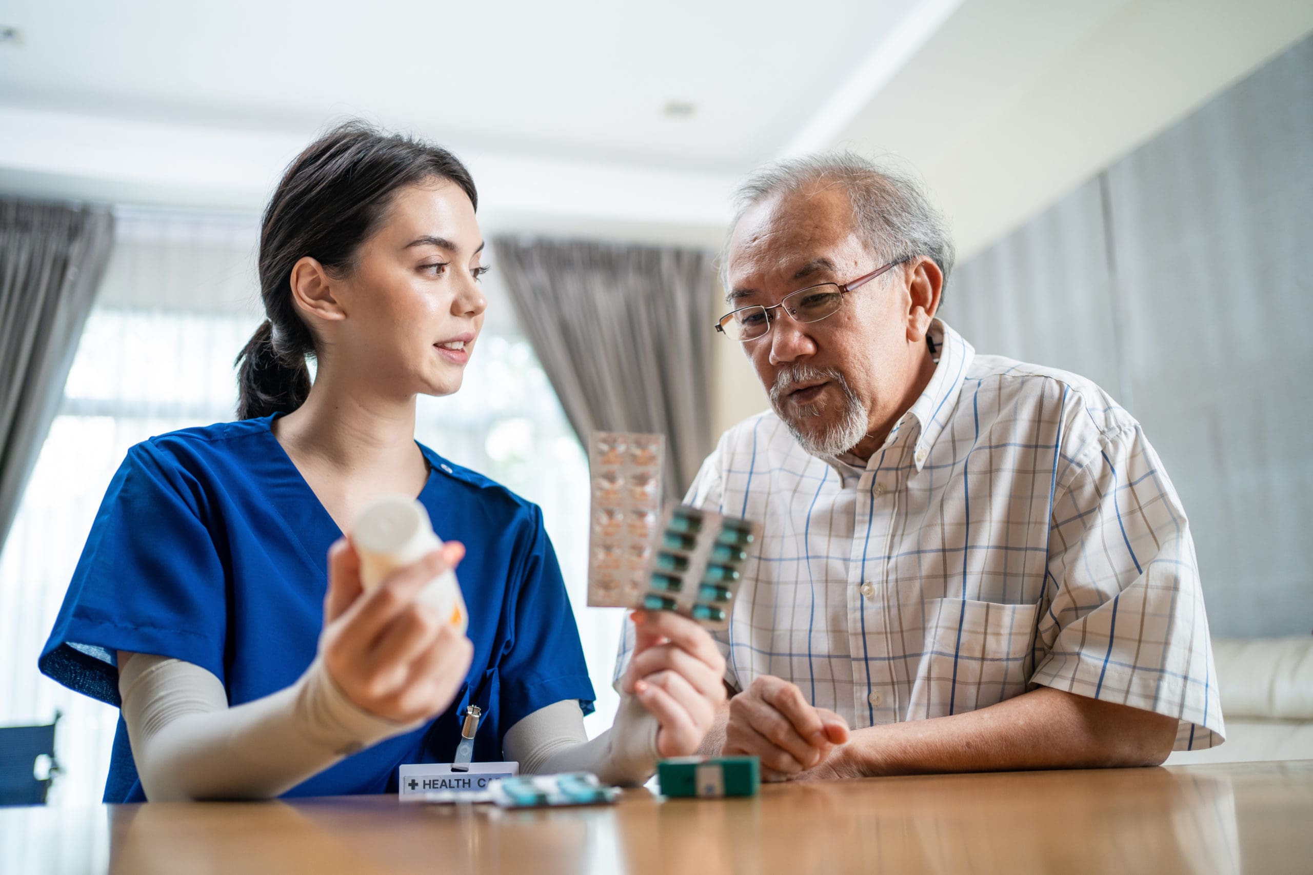 An elderly man being helped by a nurse regarding Medicare benefits.