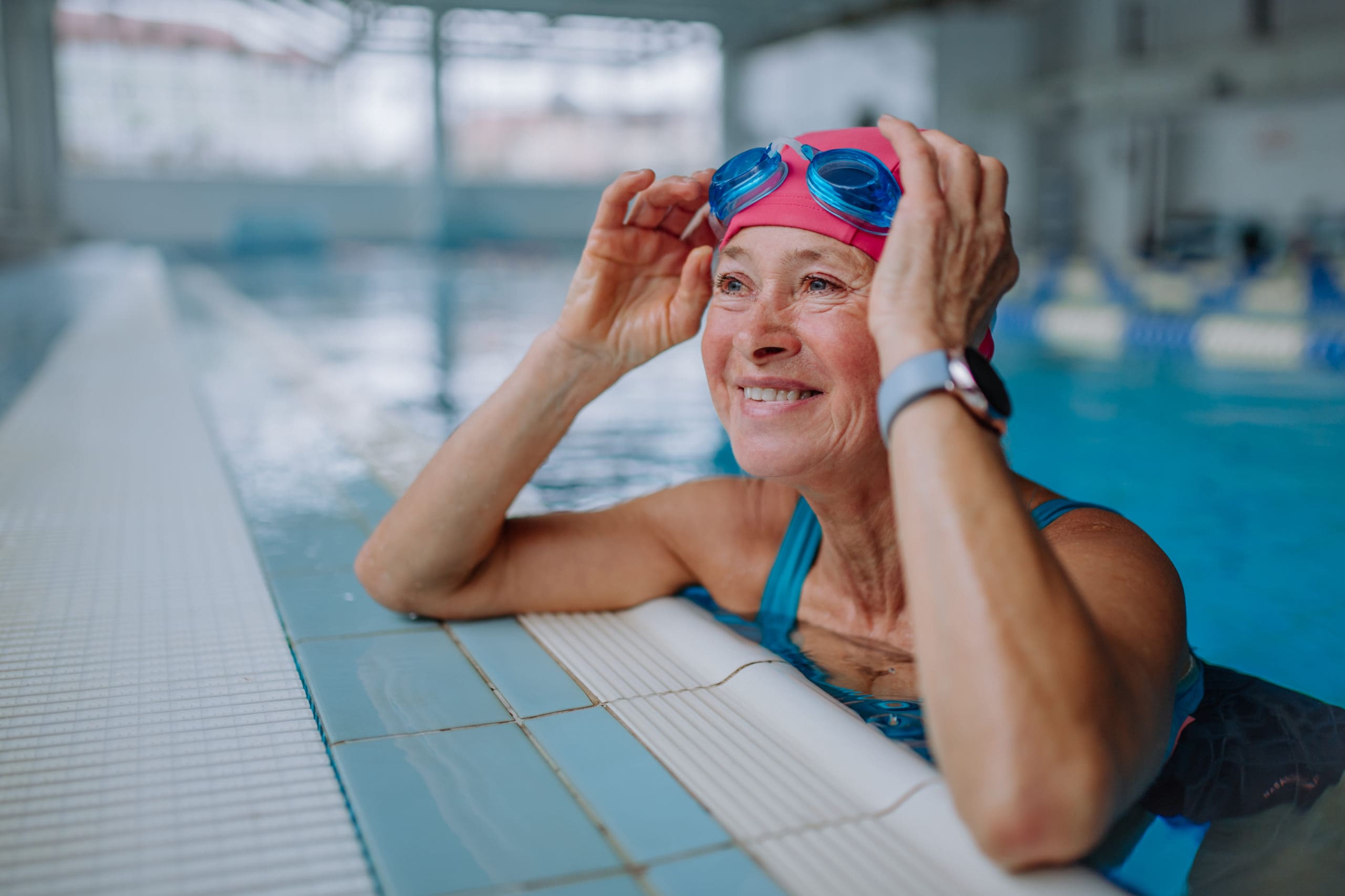 An elderly woman having swimming lessons